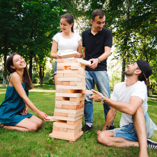 Jenga, group game of physical skill with big blocks.